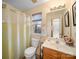 Well-lit bathroom with a shower curtain and a wooden vanity with a window view at 3229 Leicester Dr, Matthews, NC 28104