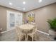 Bright dining area with a white table, comfortable seating, and a view of the outdoor patio at 3229 Leicester Dr, Matthews, NC 28104