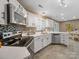 Modern kitchen with white cabinets, stainless steel appliances, and a mosaic tile backsplash at 3229 Leicester Dr, Matthews, NC 28104