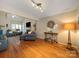 Open-concept living room with hardwood floors, comfortable seating, and stylish decor at 3229 Leicester Dr, Matthews, NC 28104