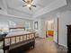 Spacious main bedroom with tray ceiling, hardwood floors, and an en-suite bathroom at 3229 Leicester Dr, Matthews, NC 28104