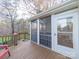 A screened sunroom with wood decking, wood ceiling, and glass door to the backyard at 3229 Leicester Dr, Matthews, NC 28104