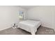Well-lit bedroom with neutral carpet, natural light, a comfortable queen-size bed, a serene retreat at 3309 Colorado Blue Ct, Gastonia, NC 28056