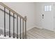 Light filled entryway with hardwood flooring, black stair railing, and white front door at 3309 Colorado Blue Ct, Gastonia, NC 28056
