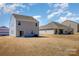 Back of a modern house shows an exterior view with a sliding glass door accessing backyard at 3309 Colorado Blue Ct, Gastonia, NC 28056