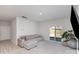 Bright living room features a gray sectional couch, and sliding glass doors leading to the yard at 3309 Colorado Blue Ct, Gastonia, NC 28056
