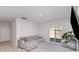 Bright living room features a gray sectional couch, and sliding glass doors leading to the yard at 3309 Colorado Blue Ct, Gastonia, NC 28056