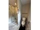 Modern bathroom featuring tiled walk-in shower and sleek glass door, plus a toilet and towel bar at 3424 Red Fox Trl, Matthews, NC 28104