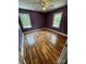 Bedroom with laminate flooring, closet, ceiling fan, and large windows at 3424 Red Fox Trl, Matthews, NC 28104