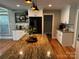 Modern kitchen features a large island with granite countertops and stainless steel appliances at 3424 Red Fox Trl, Matthews, NC 28104