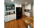 Kitchen wet bar area with granite countertops, custom shelving, and a stainless steel refrigerator at 3424 Red Fox Trl, Matthews, NC 28104