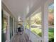 Inviting porch with rocking chairs, offering a relaxing outdoor space with views of the landscaped yard at 3424 Red Fox Trl, Matthews, NC 28104