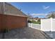 Back patio with neutral pavers and white fencing around the back yard at 3913 Sages Ave, Indian Trail, NC 28079