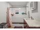 Modern bathroom features a tiled shower, neutral walls, and updated vanity at 402 N Boyd St, Gastonia, NC 28052