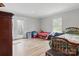 Comfortable bedroom with hardwood floors, a door leading to a backyard, and a bright, sunny window at 402 N Boyd St, Gastonia, NC 28052