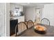 Bright eat-in kitchen with white cabinetry, stainless steel appliances, and laminate wood flooring at 402 N Boyd St, Gastonia, NC 28052