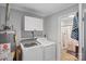 Functional laundry room with appliances and storage, conveniently located near bathroom at 402 N Boyd St, Gastonia, NC 28052