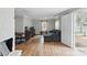 Inviting living room with hardwood floors, neutral walls, and a large sectional couch near the open door at 402 N Boyd St, Gastonia, NC 28052