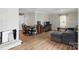 Spacious living room with wood floors, a white fireplace, and a comfortable seating area at 402 N Boyd St, Gastonia, NC 28052