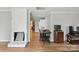 Open concept living room featuring a fireplace, dining area, and hardwood floors throughout at 402 N Boyd St, Gastonia, NC 28052