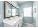 Bright main bathroom featuring a double vanity, large mirror, and modern fixtures at 4102 Harmony Hills Dr, Matthews, NC 28104