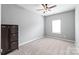 Bedroom featuring a carpeted floor, neutral walls and ceiling fan at 4102 Harmony Hills Dr, Matthews, NC 28104
