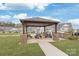 Community picnic area with charcoal grill and tables for residents at 4102 Harmony Hills Dr, Matthews, NC 28104