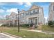 Charming townhome with grey siding, a covered front porch and manicured landscaping at 4102 Harmony Hills Dr, Matthews, NC 28104