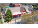 Aerial view of Moo & Brew restaurant with outdoor seating and a beer garden, surrounded by trees and greenery at 4102 Harmony Hills Dr, Matthews, NC 28104