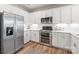 Modern kitchen featuring stainless steel appliances, white cabinets, and granite countertops at 4102 Harmony Hills Dr, Matthews, NC 28104