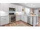 Bright kitchen showcasing stainless steel appliances, white cabinetry, and an adjacent dining area at 4102 Harmony Hills Dr, Matthews, NC 28104