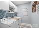 Laundry room with white cabinets, blue accents, and includes both washer and dryer at 4102 Harmony Hills Dr, Matthews, NC 28104