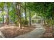 Lush green park path featuring a gazebo with picnic tables, foliage, and mature trees at 4102 Harmony Hills Dr, Matthews, NC 28104