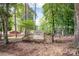 View of Baucom Park signage set amongst the trees and greenery with playground equipment visible at 4102 Harmony Hills Dr, Matthews, NC 28104