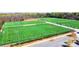Aerial view of well-maintained sports fields with vibrant green turf and clear markings in a wooded setting at 4102 Harmony Hills Dr, Matthews, NC 28104