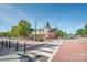 Charming building with outdoor seating, trees and a crosswalk in front for pedestrians on a beautiful day at 4102 Harmony Hills Dr, Matthews, NC 28104