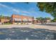 A quaint street view featuring local businesses, mature trees, and a clear blue sky at 4102 Harmony Hills Dr, Matthews, NC 28104