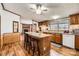 Kitchen with a granite island, wood cabinets, and view into an adjacent living room at 4285 Dc Dr, Concord, NC 28025