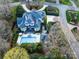 Expansive aerial view of the luxury home, pool, and manicured grounds, highlighting the estate's grandeur and amenities at 4510 Old Course Dr, Charlotte, NC 28277