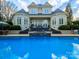Stunning backyard featuring a pool, lush landscaping, and elegant architecture at 4510 Old Course Dr, Charlotte, NC 28277