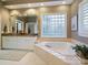Luxurious bathroom with a large soaking tub, double vanity, and unique glass block window at 4510 Old Course Dr, Charlotte, NC 28277