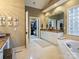 Spa-like bathroom with soaking tub, double vanity, and walk-in closet access at 4510 Old Course Dr, Charlotte, NC 28277