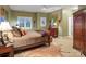Inviting bedroom featuring a comfortable bed, large dresser, and charming decor at 4510 Old Course Dr, Charlotte, NC 28277