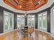 Bright breakfast nook with a unique wood ceiling, surrounding windows, and a chandelier at 4510 Old Course Dr, Charlotte, NC 28277