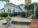 Beautiful home exterior with stone walkway, wrought iron gate, and lush landscaping offering an inviting outdoor space at 4510 Old Course Dr, Charlotte, NC 28277