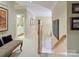 Light-filled hallway with staircase and neutral decor at 4510 Old Course Dr, Charlotte, NC 28277