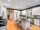 Modern kitchen with white cabinets, granite countertops, and stainless steel appliances at 4510 Old Course Dr, Charlotte, NC 28277