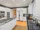 Spacious kitchen featuring granite counters, white cabinets, and hardwood floors at 4510 Old Course Dr, Charlotte, NC 28277