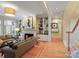 Bright living room showcasing a fireplace, built-in shelving, and hardwood floors at 4510 Old Course Dr, Charlotte, NC 28277