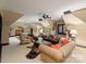 Spacious living room with unique decor, comfortable seating, and a pool table in the background at 4510 Old Course Dr, Charlotte, NC 28277